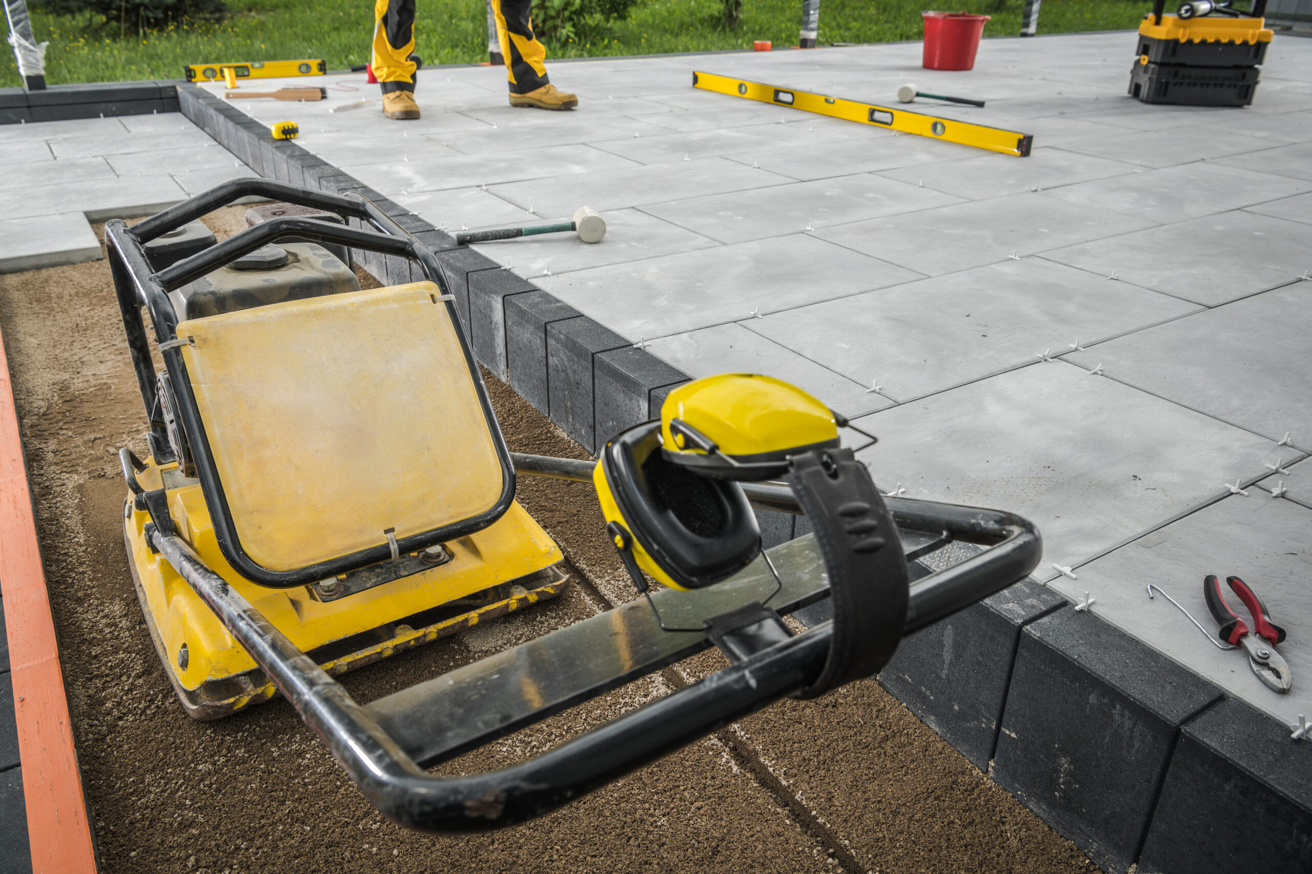Pavers being installed over a compacted base