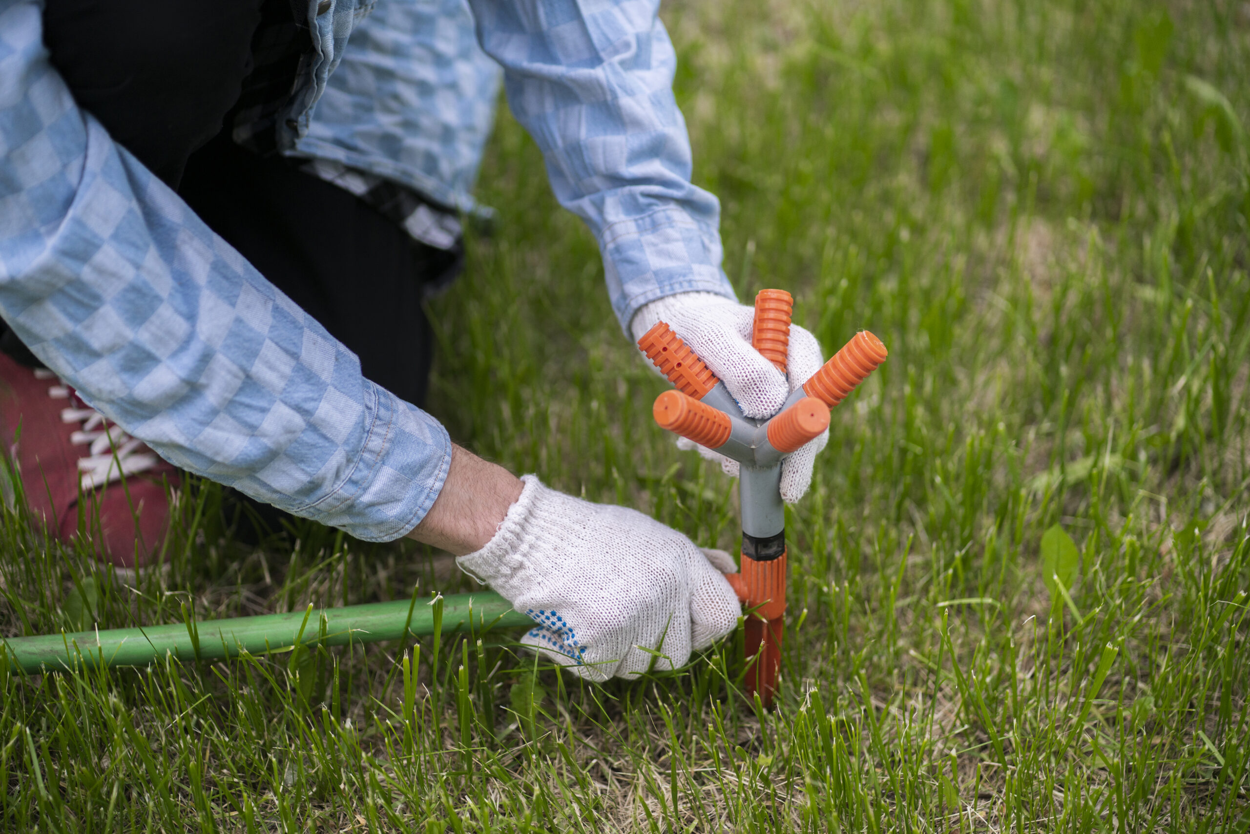 Irrigation technician adjusting a sprinkler head